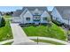Beautiful two-story home featuring a manicured lawn and a welcoming front porch at 987 Oak Terrace Rd, Westfield, IN 46074