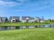 Picturesque view of homes lining a serene pond, creating a peaceful setting at 987 Oak Terrace Rd, Westfield, IN 46074