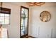 Foyer featuring a front door with glass panels, a round mirror, wainscoting, and natural light for a welcoming entrance at 987 Oak Terrace Rd, Westfield, IN 46074