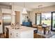 A kitchen island with seating overlooks the breakfast area, with access to the patio via sliding glass doors at 987 Oak Terrace Rd, Westfield, IN 46074