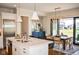 Bright kitchen features an island, stainless steel appliances, and an adjacent dining area with sliding glass doors at 987 Oak Terrace Rd, Westfield, IN 46074