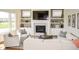 The living room features a fireplace with a tv mounted above, built in shelving, and ample seating at 987 Oak Terrace Rd, Westfield, IN 46074