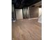 Finished basement featuring vinyl floors, white trim, and wood paneled wall accents at 1008 E 61St St, Indianapolis, IN 46220