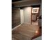 Finished basement with view of new bathroom; featuring vinyl floors and wood panel accents at 1008 E 61St St, Indianapolis, IN 46220