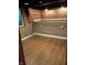Unfinished basement space featuring vinyl floors, paneled accent walls, and storage at 1008 E 61St St, Indianapolis, IN 46220