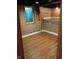 Unfinished basement space with wood-look flooring and window, offering potential for customization at 1008 E 61St St, Indianapolis, IN 46220