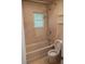 Traditional bathroom with a shower over the bathtub, a window, and a toilet at 1008 E 61St St, Indianapolis, IN 46220