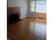 Bright living room featuring a classic brick fireplace and hardwood floors at 1008 E 61St St, Indianapolis, IN 46220