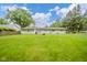 Lush backyard with a well-maintained lawn, complemented by the home's exterior and surrounding trees at 10097 N Balfer E Dr, Fortville, IN 46040