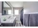 Bathroom with updated vanity, modern fixtures, large mirror, and shower at 10097 N Balfer E Dr, Fortville, IN 46040