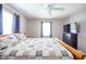 Comfortable bedroom with a ceiling fan, windows, and a dark dresser at 10097 N Balfer E Dr, Fortville, IN 46040