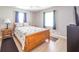 Cozy bedroom with neutral walls, wood floors, and natural light from the windows at 10097 N Balfer E Dr, Fortville, IN 46040
