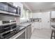 Bright kitchen features stainless appliances, tile floors and white cabinets at 10097 N Balfer E Dr, Fortville, IN 46040