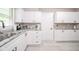 Well-lit kitchen featuring white cabinetry, stainless steel appliances, and granite countertops at 10097 N Balfer E Dr, Fortville, IN 46040
