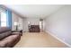 Spacious living room with hardwood floors, comfortable seating, and neutral paint at 10097 N Balfer E Dr, Fortville, IN 46040