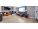 Comfortable living room featuring hardwood floors, a fireplace, and large windows with blue curtains at 10097 N Balfer E Dr, Fortville, IN 46040