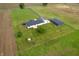 Aerial view of home featuring a back deck, large shed, and fire pit situated on expansive green land at 10274 S 400 W, Pendleton, IN 46064