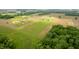 Aerial view of home, outbuilding, and pool surrounded by farmland and green space at 10274 S 400 W, Pendleton, IN 46064
