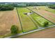 Stunning aerial view of property, featuring a home, outbuilding, and expansive green space with a clearly marked boundary at 10274 S 400 W, Pendleton, IN 46064