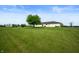 Expansive backyard with lush green lawn and a white modern farmhouse at 10274 S 400 W, Pendleton, IN 46064