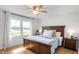 Serene bedroom with a wooden bed frame, natural light, and a calming view at 10274 S 400 W, Pendleton, IN 46064