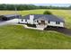 Stunning white brick home featuring a black roof, landscaped yard, and a detached garage at 10274 S 400 W, Pendleton, IN 46064