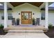 Inviting front porch with rocking chairs, a stylish rug, and double-door entry at 10274 S 400 W, Pendleton, IN 46064