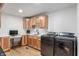 Spacious laundry room with wooden cabinetry, a countertop workspace, and modern washer and dryer units at 10274 S 400 W, Pendleton, IN 46064