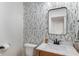 Stylish powder room featuring floral wallpaper, a marble countertop, and modern fixtures at 10274 S 400 W, Pendleton, IN 46064