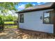 The rear of this home shows an expansive wooden deck and blue siding with brown trim at 10560 Lighthouse Way, Indianapolis, IN 46256