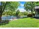 The lush backyard features mature trees, a pond, and manicured lawn at 10560 Lighthouse Way, Indianapolis, IN 46256