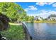 Scenic backyard view of the lake with a fence line and grassy area at 10560 Lighthouse Way, Indianapolis, IN 46256