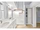 Bathroom features a double vanity, frameless shower, and closet at 10560 Lighthouse Way, Indianapolis, IN 46256