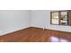 Cozy bedroom with hardwood floors and a window with outside views at 10560 Lighthouse Way, Indianapolis, IN 46256