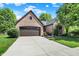 Attractive brick home with a spacious driveway, two-car garage, and neatly manicured lawn at 10560 Lighthouse Way, Indianapolis, IN 46256
