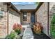 Charming entryway featuring colorful bushes, attractive landscaping, and a brick facade at 10560 Lighthouse Way, Indianapolis, IN 46256