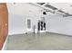 Clean garage with epoxy flooring, water heater, water softener and neutral paint at 10560 Lighthouse Way, Indianapolis, IN 46256