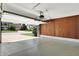 Spacious two-car garage with an open door showing the neighborhood at 10560 Lighthouse Way, Indianapolis, IN 46256