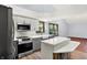 This updated kitchen features stainless steel appliances, stylish backsplash and a vaulted ceiling at 10560 Lighthouse Way, Indianapolis, IN 46256