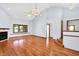 Spacious living room with high ceilings, a fireplace, and beautiful hardwood flooring at 10560 Lighthouse Way, Indianapolis, IN 46256
