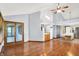 Bright living room with hardwood floors, a patio door, and an open layout to the kitchen at 10560 Lighthouse Way, Indianapolis, IN 46256