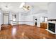 Open living space with hardwood floors, a fireplace, and vaulted ceilings for a modern feel at 10560 Lighthouse Way, Indianapolis, IN 46256