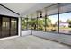 Light-filled sunroom featuring serene views of the water and access to outdoors at 10560 Lighthouse Way, Indianapolis, IN 46256