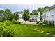 An expansive backyard offers lush greenery and a stepping stone pathway leading to a charming home at 10833 Marquette Rd, Zionsville, IN 46077