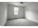 This light and airy bedroom features two windows and neutral carpet and paint at 10833 Marquette Rd, Zionsville, IN 46077