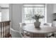 Bright dining area featuring a round table, comfortable seating, and a window offering natural light at 10833 Marquette Rd, Zionsville, IN 46077