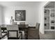 Formal dining room featuring dark wood table, chairs and natural light from adjacent window and doorway at 10833 Marquette Rd, Zionsville, IN 46077