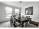 Formal dining room with a dark wood table, seating for six, and large windows for ample light at 10833 Marquette Rd, Zionsville, IN 46077