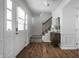 Bright foyer features hardwood floors, stairway, and door with leaded glass window at 10833 Marquette Rd, Zionsville, IN 46077