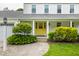 Inviting front entrance features a bright yellow door, manicured landscaping, and a well-lit walkway at 10833 Marquette Rd, Zionsville, IN 46077